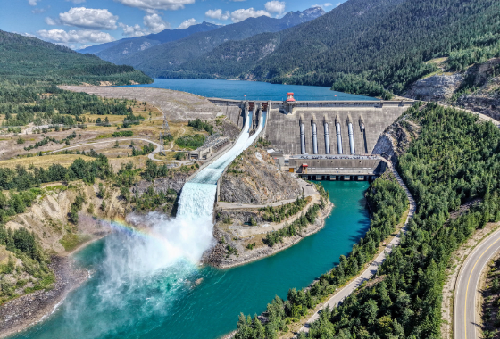 Revelstoke Dam spilling with a rainbow coming from the spillway.